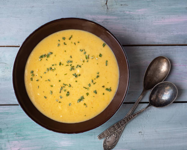 istock Homemade soup-mashed vegetables on mushroom broth in a deep dish and tablespoons 1174942295