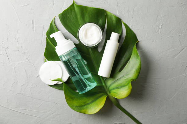 istock Flat lay with body care accessories and palm leaf on grey background, copy space 1174943596