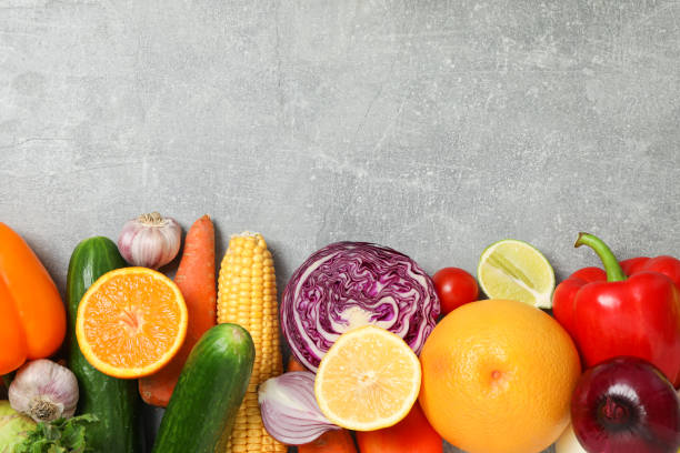 istock Different vegetables and fruits on grey background, copy space 1174945078