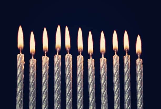 istock Burning birthday candles on blue background 1174945200