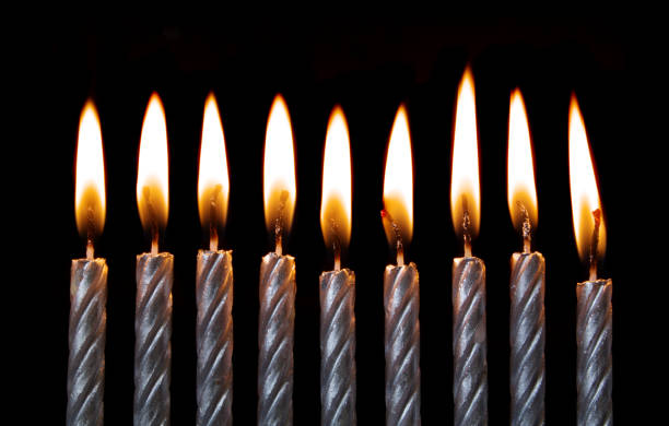 istock Silver burning birthday candles on black 1174945224