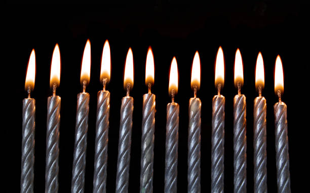 istock Silver burning birthday candles on black 1174945228