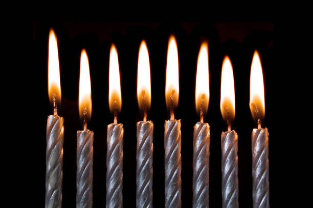 istock Silver burning birthday candles on black 1174945232