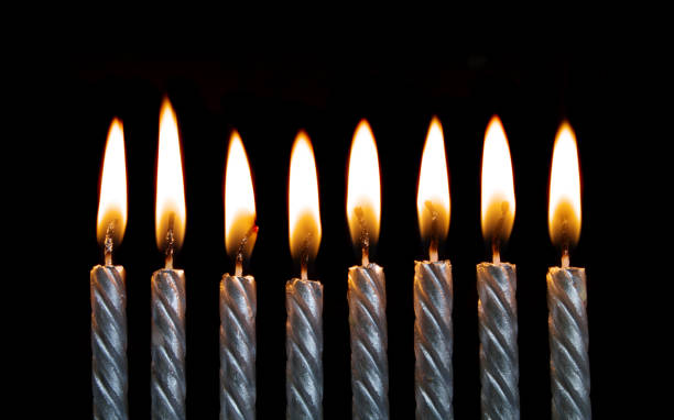 istock Silver burning birthday candles on black 1174945259