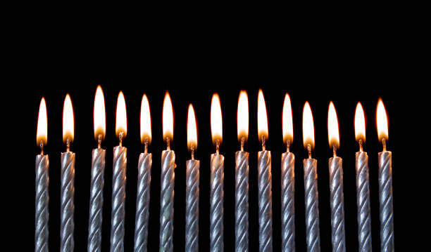 istock Silver burning birthday candles on black 1174945270