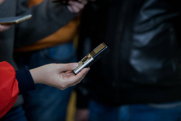 istock voice recorder phone microphone in hand, press conference 1174945412