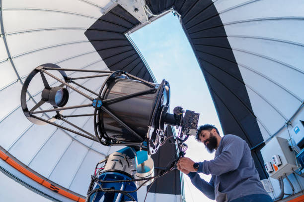 Astronomer in photo telescope dome Astronomer in photo telescope dome daylight checking settings for the coming night observatory photos stock pictures, royalty-free photos & images