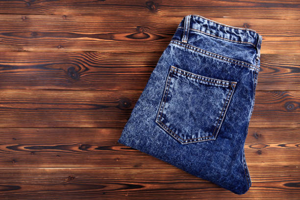 istock blue denim jeans  on wooden background - Image 1174947703