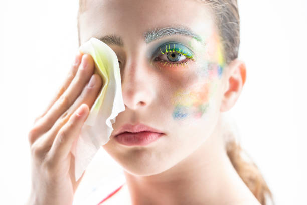 girl cleansing makeup with wipes on white