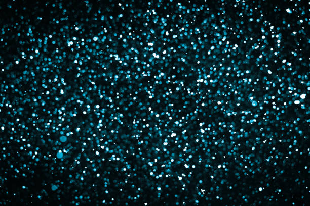 istock Defocused blue Lights and Sparkles on the black background 1174948243
