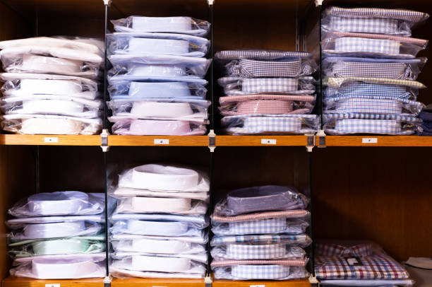 istock Shirts on shelves in shop 1174948296