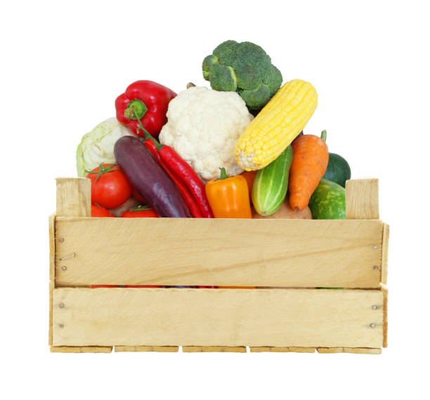 istock Vegetables in wooden crate isolated on white 1174949601