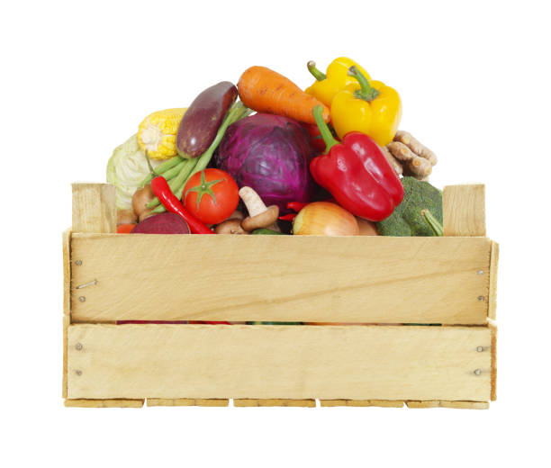 istock Vegetables in wooden box isolated on white 1174949687