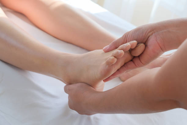 Foot massage in spa salon, closeup stock photo
