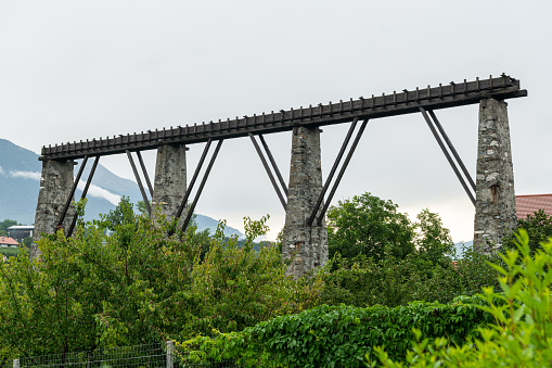 Remains of the old aqueduct in Laas (South Tyrol, Italy) on a cloudy day in summer