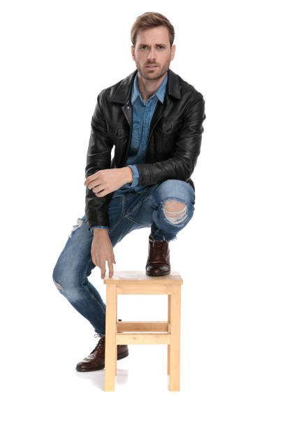 istock man standing with one leg down and one on chair 1174951145