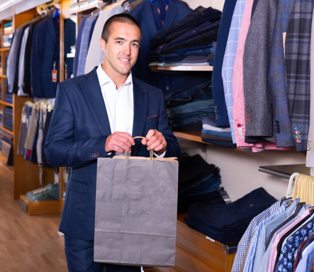 istock Happy man holding paper bag after shopping 1174952209