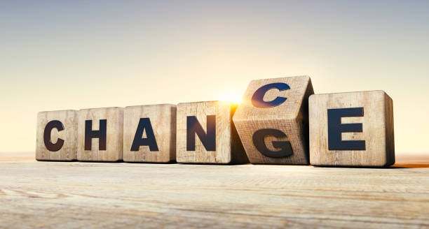 Wodden dice on a table form the words chance and change