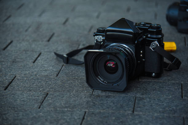 istock old full-frame film camera lying on paving slabs 1174955204