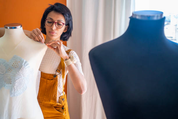 istock Fashion designer dressmaker working with mannequins 1174961002