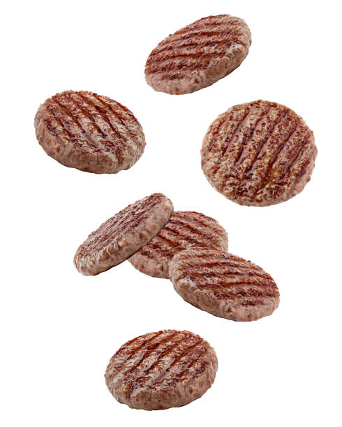 Falling grilled hamburger meat isolated on white background, clipping path, full depth of field Falling grilled hamburger meat isolated on white background, clipping path, full depth of field burgers stock pictures, royalty-free photos & images
