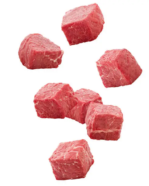 Photo of Falling meat, beef, cube, isolated on white background, clipping path, full depth of field