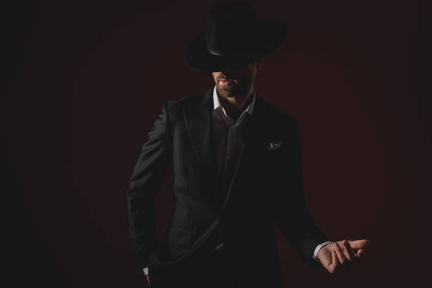 istock mysterious young man wearing tuxedo and presenting to side 1174964686