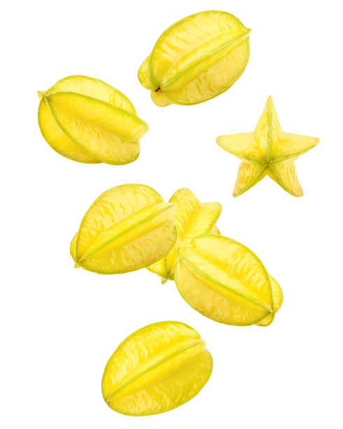 Falling carambola, starfruit, isolated on white background, clipping path, full depth of field Falling carambola, starfruit, isolated on white background, clipping path, full depth of field starfruit stock pictures, royalty-free photos & images