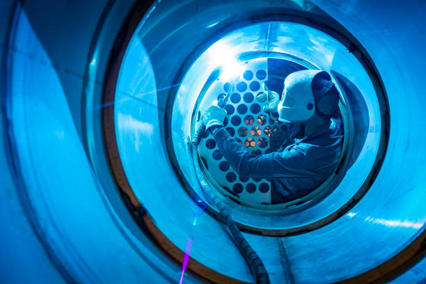 welder man welding a multitubular heat exchanger - confined space flash imagens e fotografias de stock