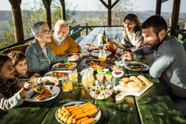 istock Happy extended family talking during lunch on a terrace. 1174967327