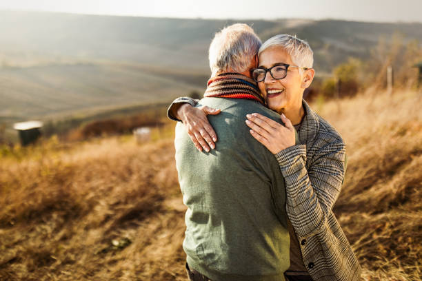 istock Embraced senior couple in autumn day on a field. 1174972737