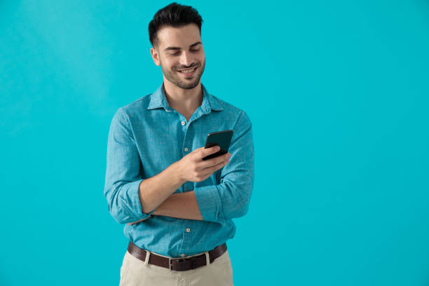 istock man with arms crossed looking at phone 1174972769
