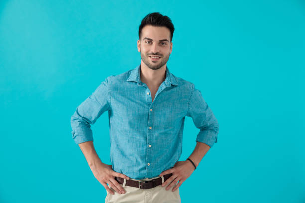 istock man in blue shirt standing with hands on waist 1174972903