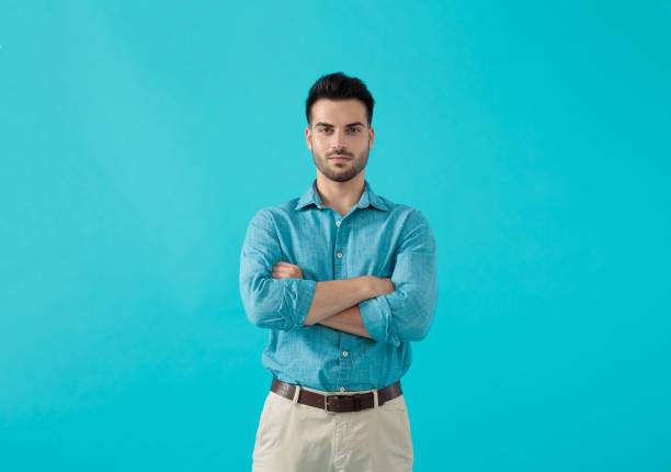 istock man in blue shirt standing with arms crossed 1174972910