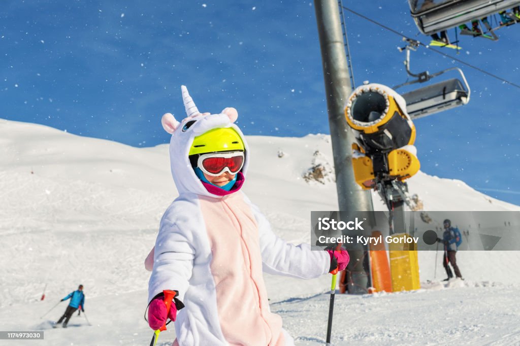 Cute Adorable Preschooler Caucasian Kid Girl Portrait With Ski In Helmet  Goggles And Unicorn Fun Costume Enjoy Winter Sport Activities Little Child  Skiing On Luxury Alpine Resort In Mountains Stock Photo 