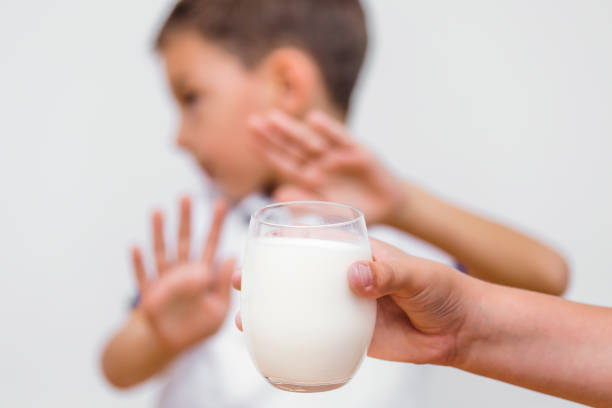 istock Kid refusing to drink milk. Lactose intolerance. Dairy Intolerant child refuses to drink milk 1174973917