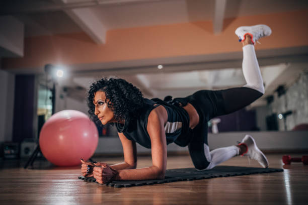 istock Fit woman training on the floor in gym 1174974712