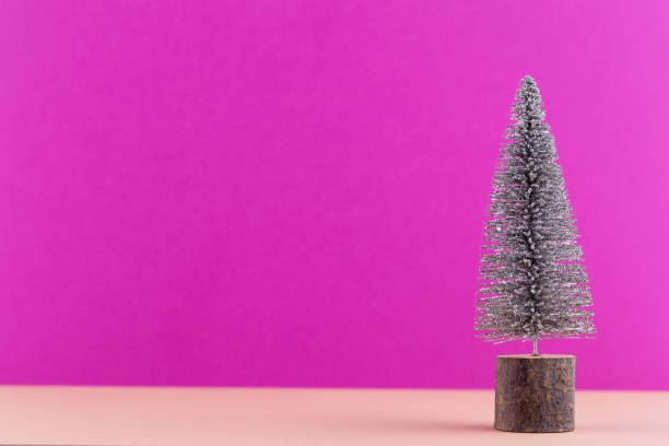 istock Christmas tree on pastel colored background. Christmas or New Year minimal concept. 1174977505
