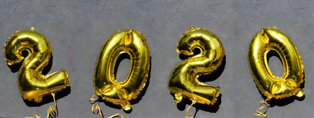 istock Yellow 2020 balloons against the dark surface 1174978638