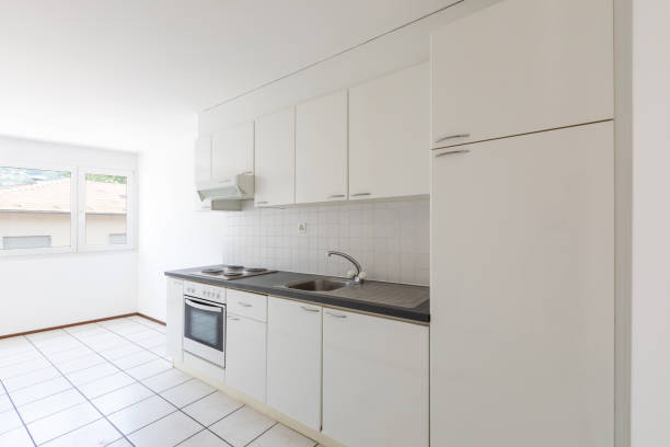 istock Empty room with vintage kitchen, white tiles and walls 1174979629