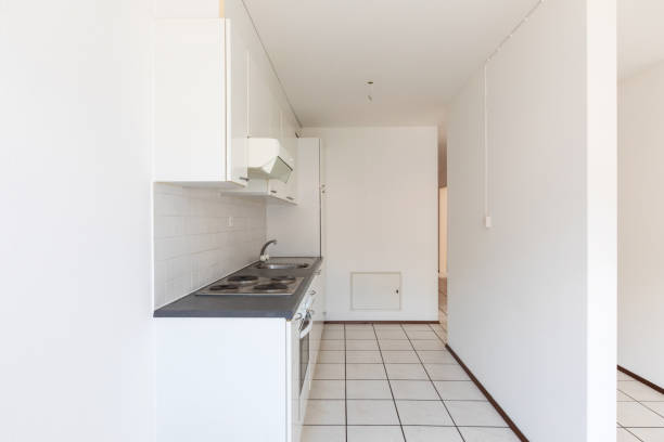 istock Empty room with vintage kitchen, white tiles and walls 1174981001