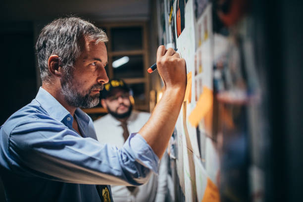 istock Men detectives looking for clues 1174981407