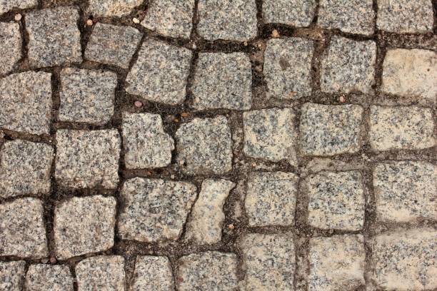 istock Granite cube, Overhead view of cobblestone street texture 1174981536