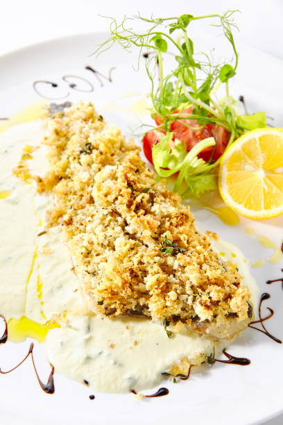 istock Breaded Pike Perch or Zander Fillet with Cream Sauce Isolated 1174982610