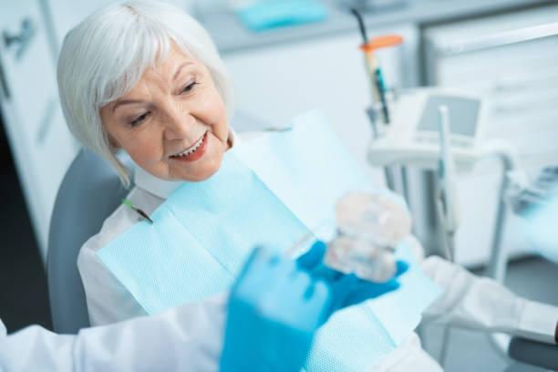 istock Dentist explaining to patient how to treating teeth 1174982957