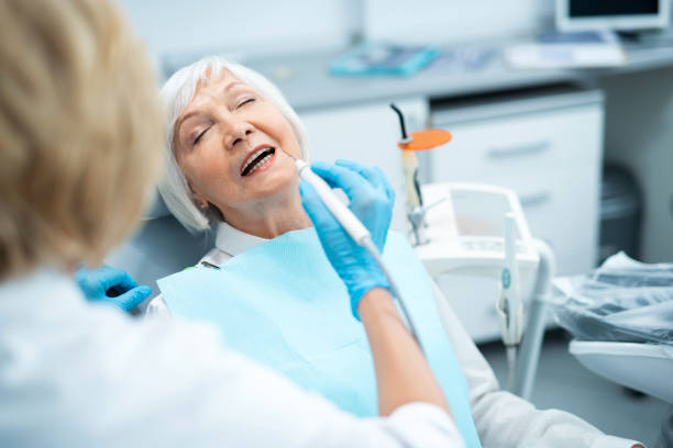 istock Female dentist is treating teeth for patient 1174983189