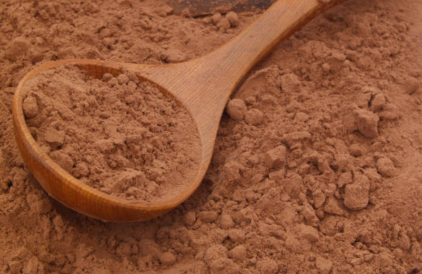istock Cacao powder with wooden spoon 1174984850