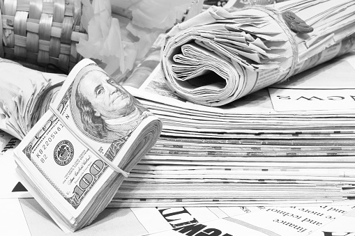 Newspapers and Bundle of Money. Stack of Magazines and One Hundred Dollar Bills. Tabloid Journals and Cash, Concept for Business and Finance