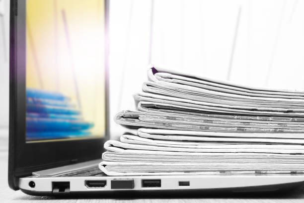 istock Newspapers and Laptop 1174986339