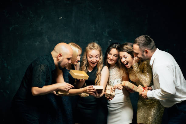 istock Friends exchanging and opening festive presents 1174986767